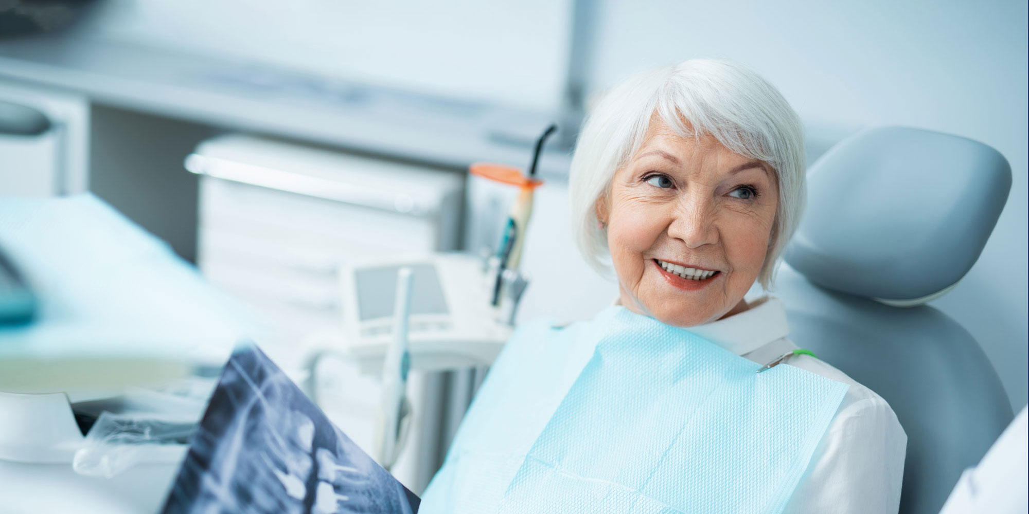 older dental patient discussing dental implants