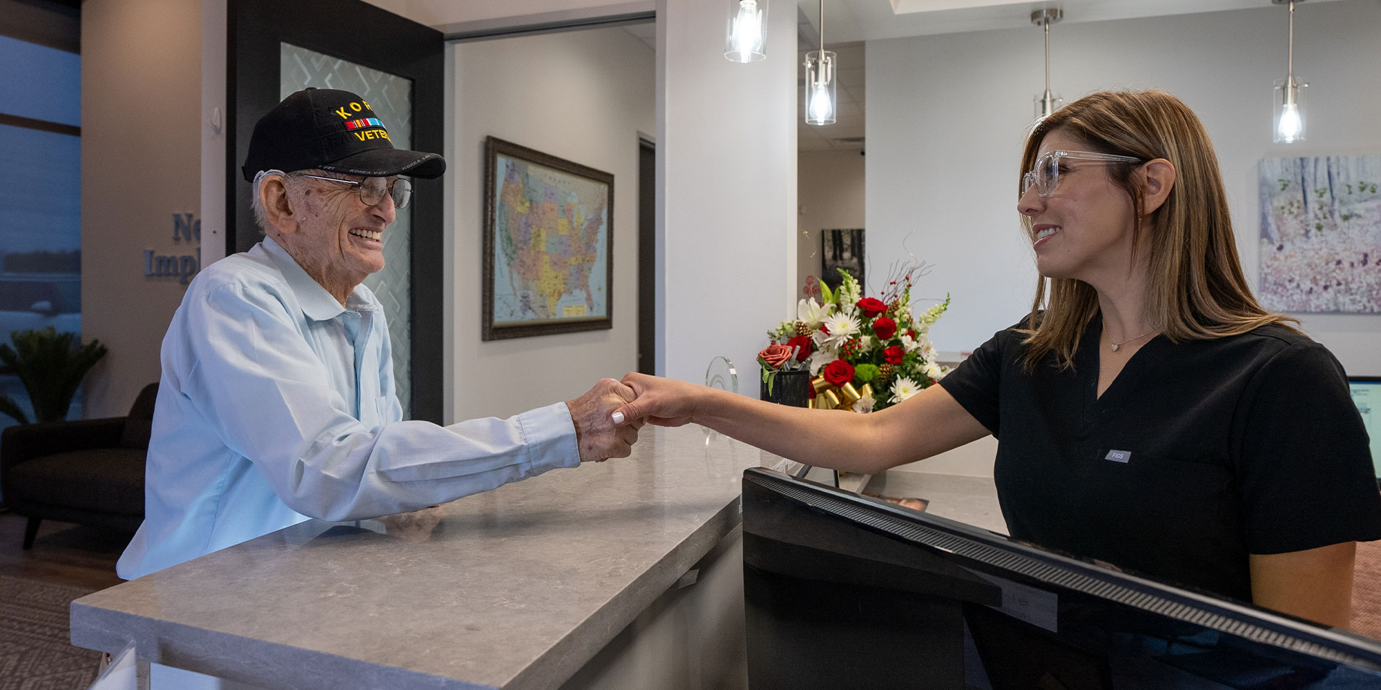 henry with front desk associate at newme