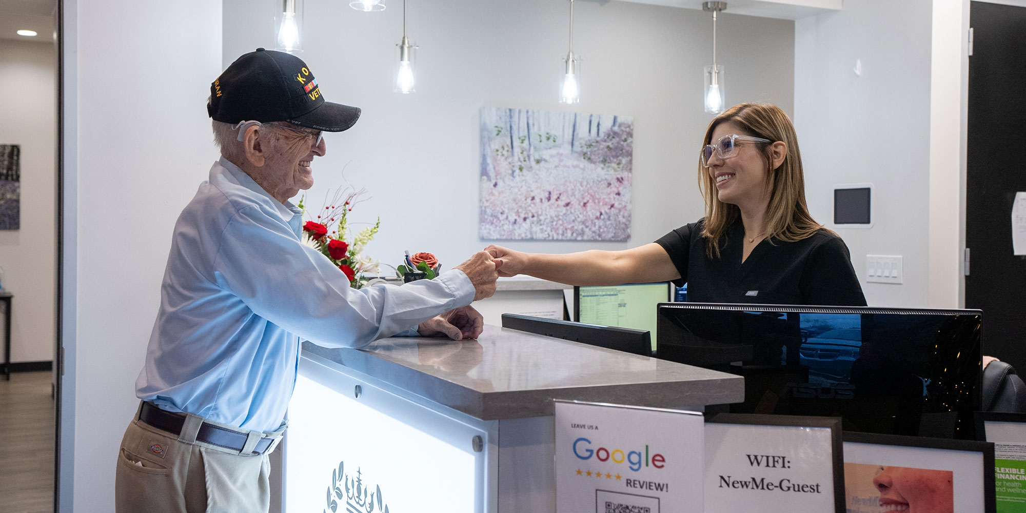 henry with office lady talking dental implant pricing