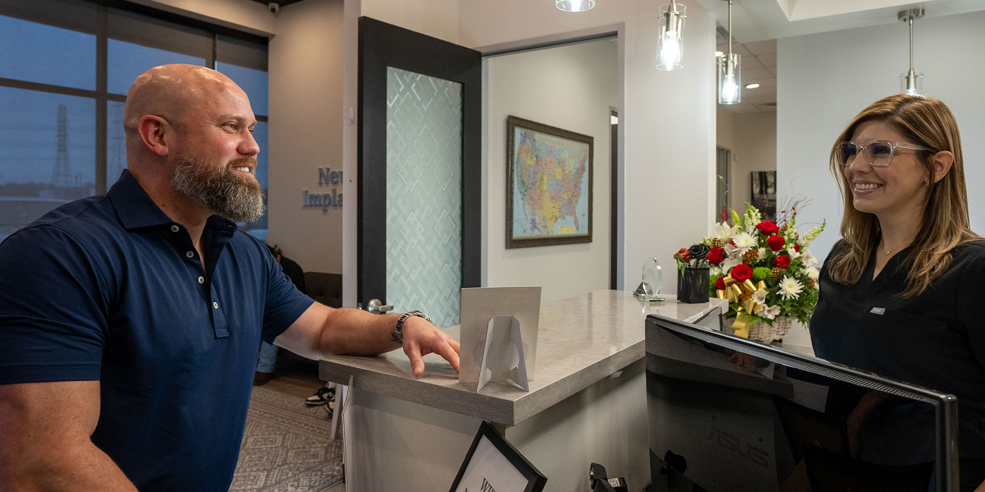 matt talking to the front desk with his new full arch dental implants
