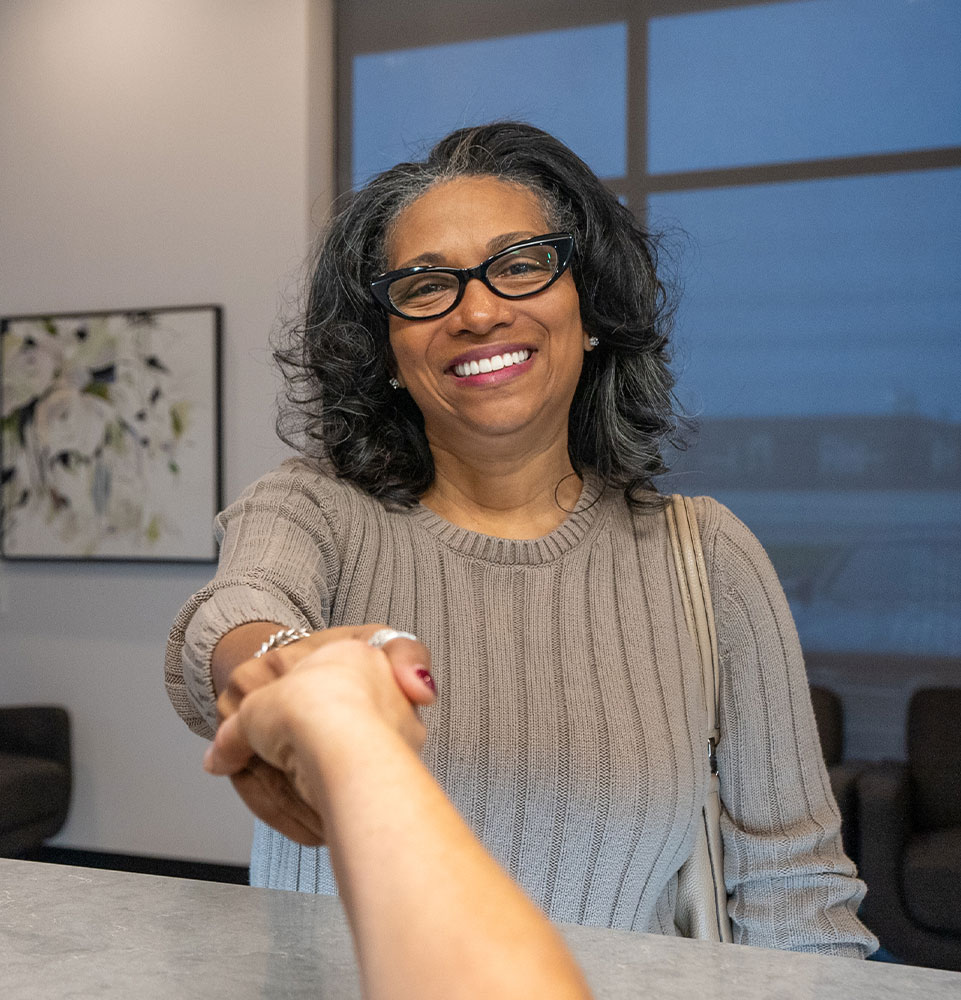 yolanda smiling shaking hands