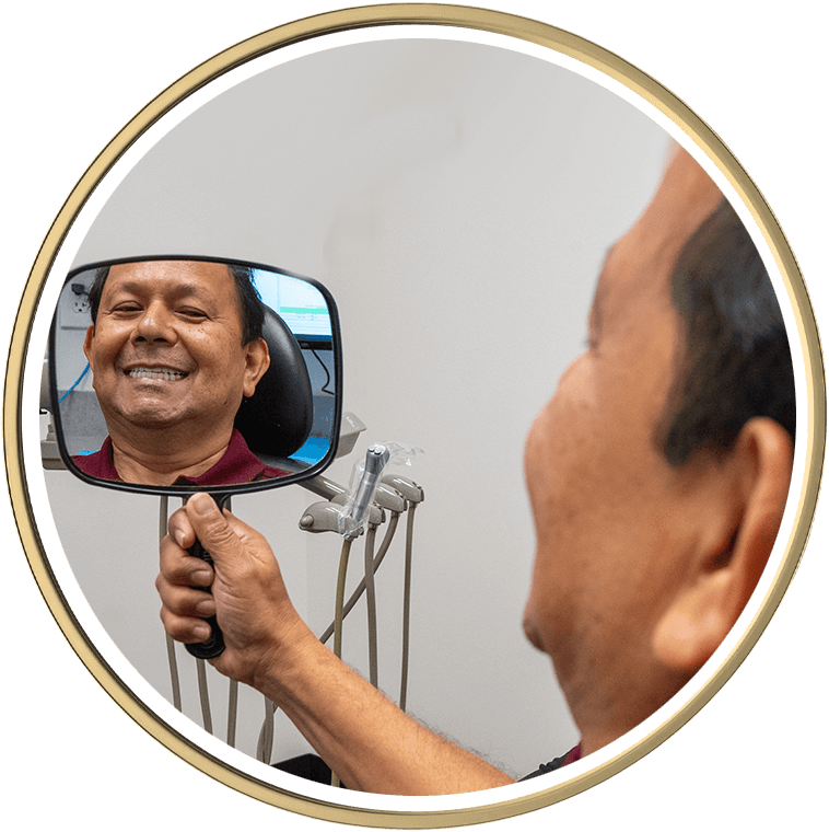 Patient smiling into mirror